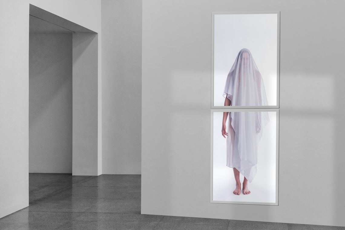 Apparition: installation view, illuminated veiled figure